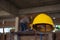 Yellow safety helmet with construction worker placing bricks on