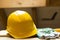 Yellow safety helmet and gloves on working surface at attic renovation site