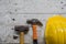 yellow safety helmet and rolled up architectural blueprints on a wooden desk