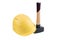 Yellow safety helmet on a small sledgehammer with wooden handle isolated on a white background, surface. Path saved, cut out. Cons