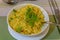 Yellow saffron rice with green garnish
