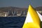 yellow sail boat race marker floating on aegean sea. Mock up poster on the yellow buoy