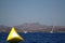 yellow sail boat race marker floating on aegean sea. Mock up poster on the yellow buoy