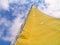 Yellow sail yacht on sky background