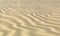 Yellow sand on beach with waves under day sun light closeup