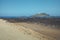 Yellow sand beach and white lighthouse on the island