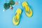 Yellow sandals on blue color background, Summer holidays accessories
