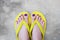 Yellow Sandals. Selfie Womanâ€™s Sandals Feet with Violet Nail Pedicure of Paint on Cement Background