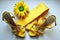 Yellow sandals, tie and flower for wedding on the white background.