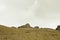 A yellow sandy mountain hills with rocks