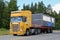 Yellow Scania 164G Truck Hauls Portable Cabin
