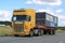 Yellow Scania 164G Truck Hauls Portable Cabin