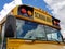 Yellow school bus with cloud reflection