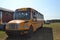 A Yellow School Bus Parked On The Grass