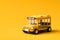 Yellow school bus on vivid yellow background with back to school concept. Classic school bus automobile. 3D rendering