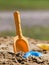 Yellow scoop and blue form in sand