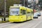 Yellow Seattle streetcar on East Yesler Way with pantograph down