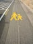 Yellow sidewalk sign on asphalt