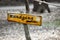 Yellow sign on a crooked branch with German inscription tour around