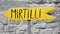 Yellow sign with italian writing `mirtilli` meaning in english `bluberries`