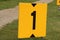 Yellow sign at rowing facility in Zeven huizen with the number 1