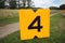 Yellow sign at rowing facility in Zeven huizen with the number 4