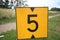 Yellow sign at rowing facility in Zeven huizen with the number 5