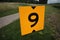 Yellow sign at rowing facility in Zeven huizen with the number 9