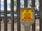 A yellow sign warning of an Intermediate Pressure IP gas pipeline at an Above Ground Installation AGI in the UK. Part of the