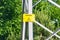 Yellow signboard danger on an iron electric pole