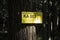 The yellow signboard of rescue point on a tree in a forest in Czech Republic