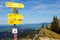 Yellow signposts on mountain top by panoramic view