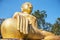 Yellow sitting Budha image with blue sky