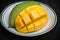 Yellow sliced on cubes mango on plate