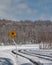 Yellow slippery driving sign and snowy road, Niseko, Hokkaido, Japan