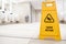 Yellow slippery warning sign, caution wet floor sign in the toilet room