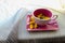 Yellow small dandelions in a pink cup and saucer