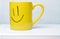 Yellow smile cup on white background