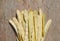 Yellow snap bean pods on rugged wood background
