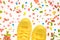Yellow sneakers on colorful springtime decorated surface