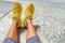 Yellow sneakers girl wearing fashion style activewear colorful running shoes at gym outdoor. POV selfie of footwear