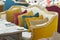 Yellow sofa in a luxurious restaurant with a few colorful pillow