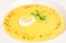 Yellow soup with egg and greens