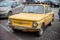 Yellow soviet Zaz 968 car is parked on the roadside