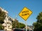 Yellow speed humps caution sign hinging in residential area on sunny day