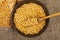 Yellow split peas in a cellophane bag and cereals in a ceramic bowl on a background of coarse-textured burlap. Traditional cereals