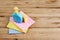 Yellow sponge, blue plastic bottle, with color clothes on wooden table