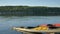 yellow sports kayak on water near bank of tranquil lake