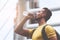 Yellow sporty guy drinking water in hot day outdoor