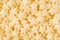 Yellow stars corn flakes closeup background, cereals texture.